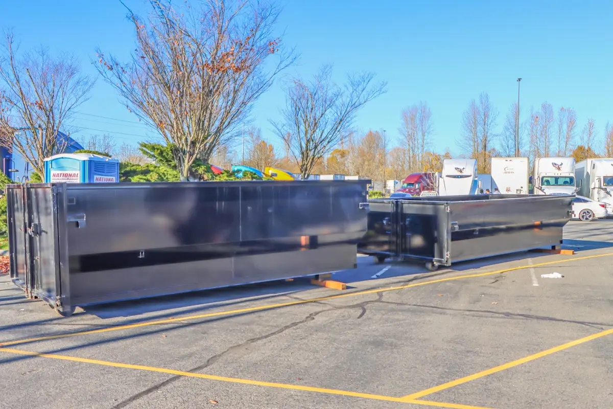 Professional dumpster rental service with roll-off container on residential driveway in South Houston